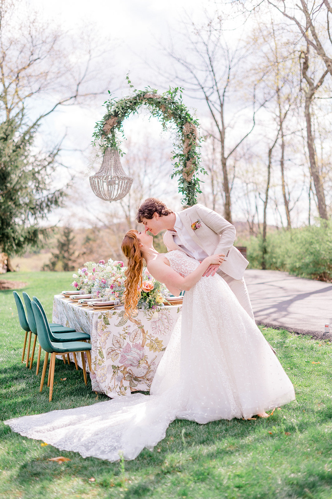 whimsical chandelier lighting over outside wedding table