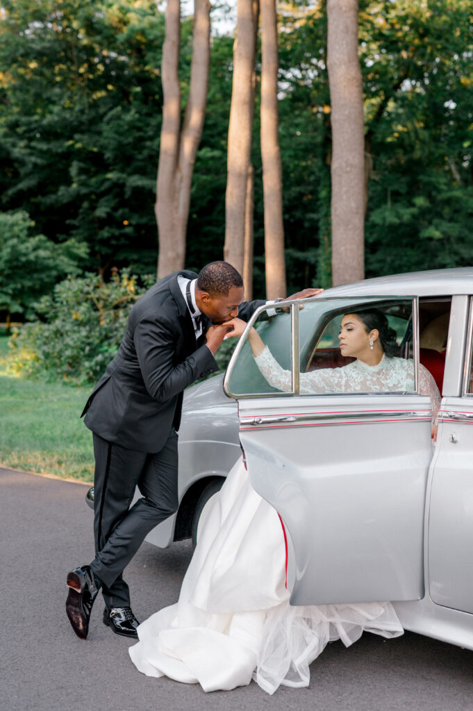 bride and groom next to a vintage car