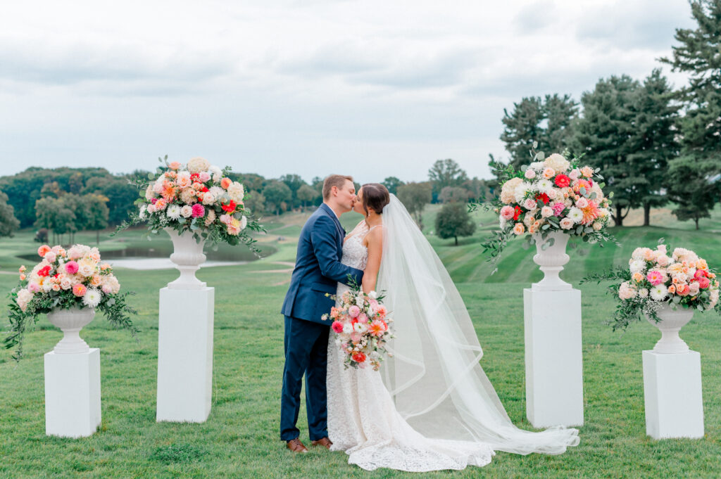 bright pink and coral wedding ceremony florals