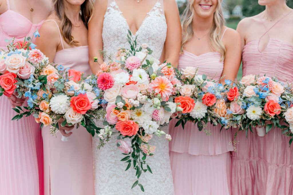 bride and bridesmaids holding colourful bouquets