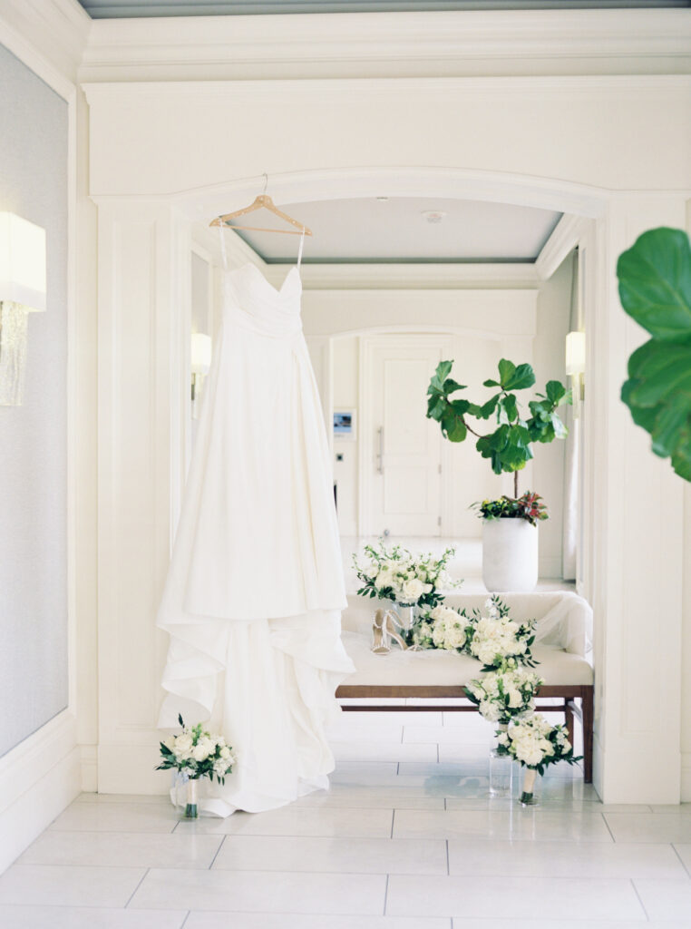 Film photo of brides dress hanging in bridal suite. 