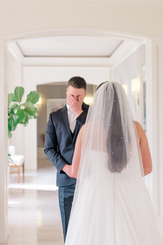 Groom turns around, crying, as he sees his new bride for the first time. 