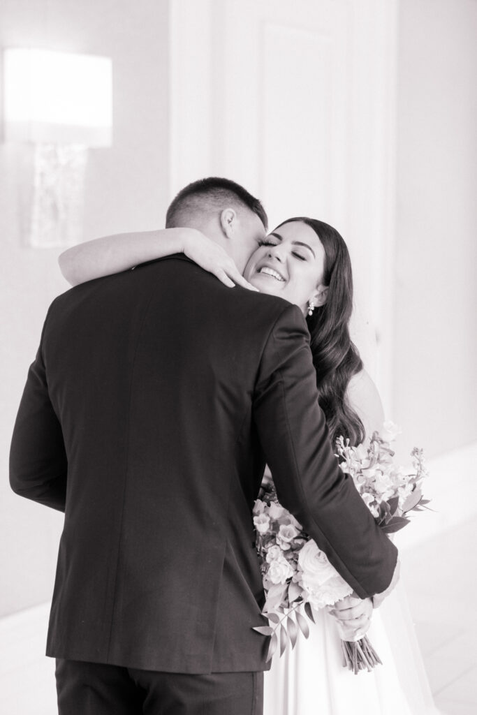 Bride and groom hug after first look before wedding at the Ritz Carlton Amelia Island. 