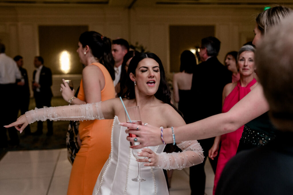 Bride dances to live band during her wedding reception. 