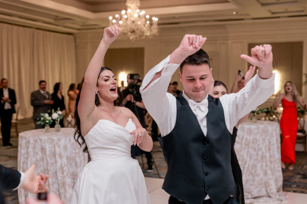 Bride and groom making grand entrance to reception. 