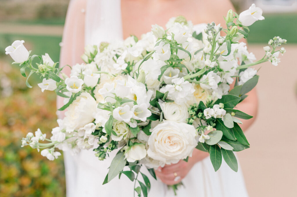 Monochromatic white bridal bouquet with greenery. 