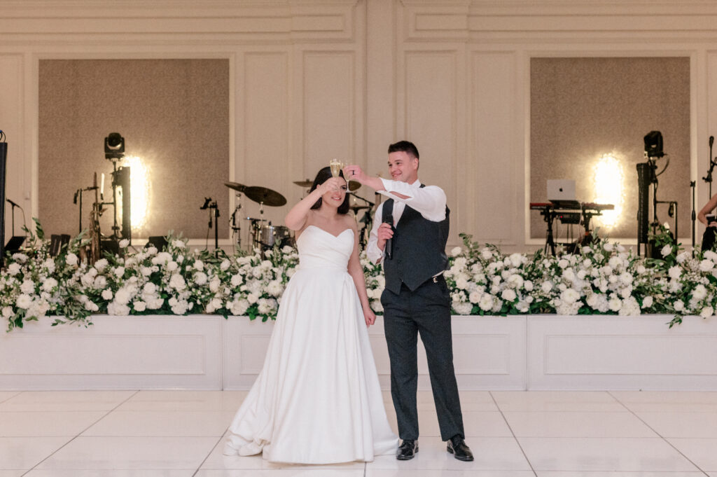 Bride and groom giving toast during their wedding reception, thanking guests for being their for their journey. 