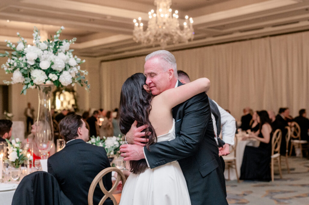 Bride hugging her dad after sharing first dance. 