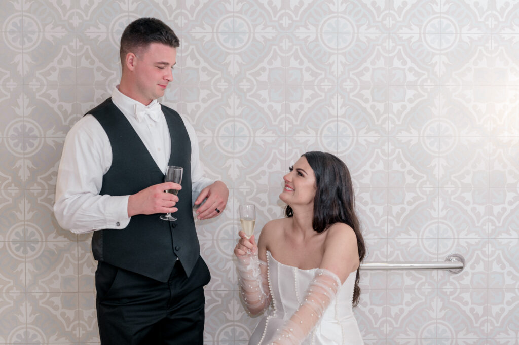 Bride and groom toast with their champagne flutes. 