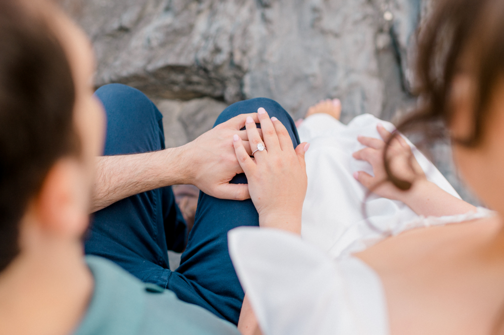 close up photo of couples hands and engagement ring