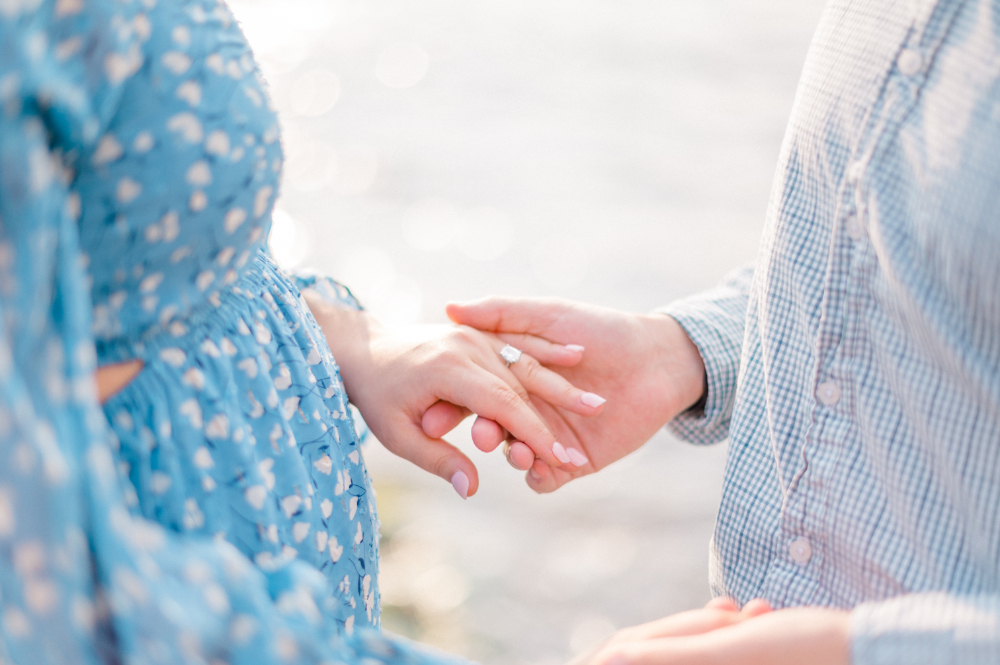 couple engagement photo of hands and engagement ring