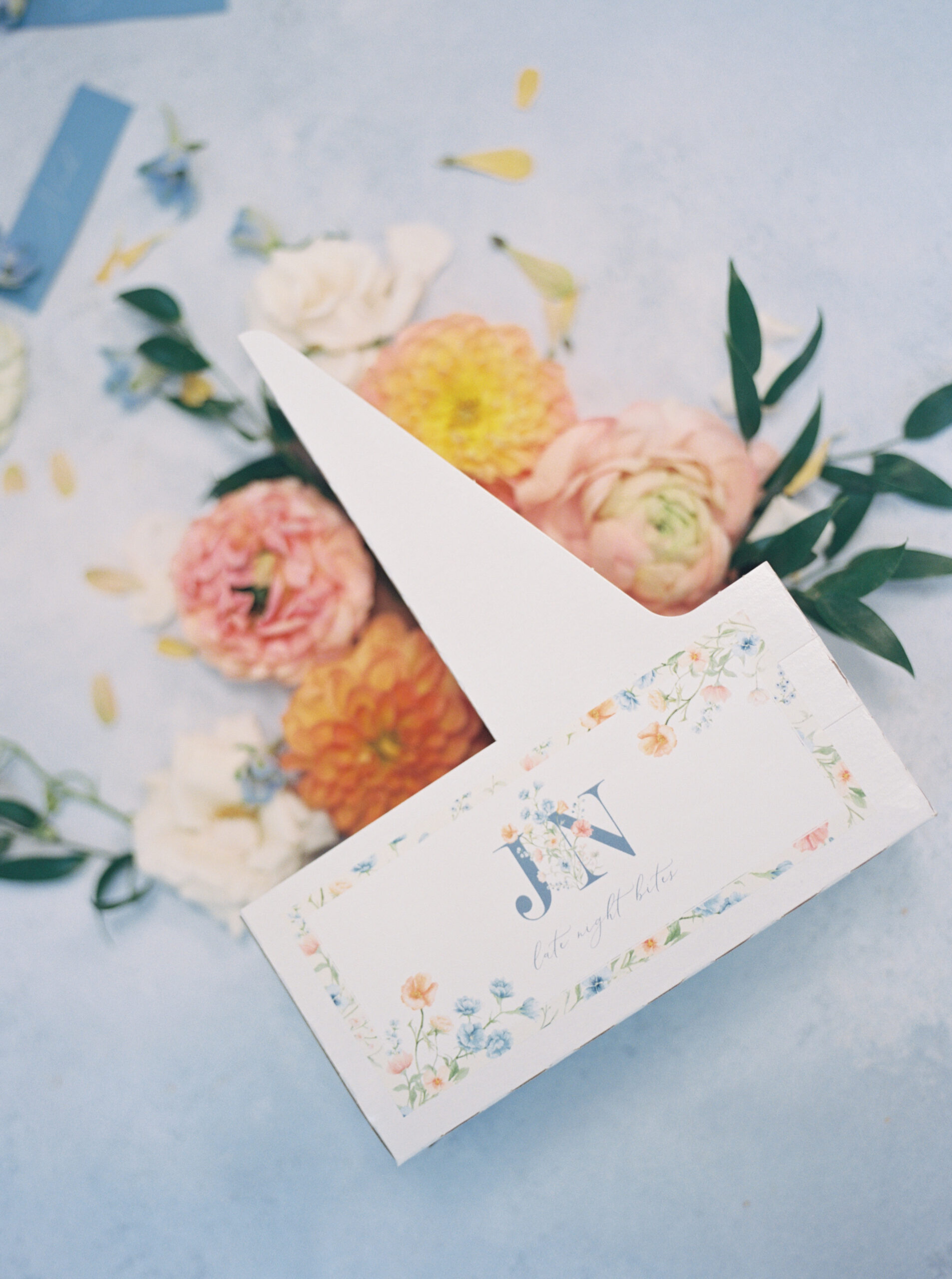 place card with florals surrounding it