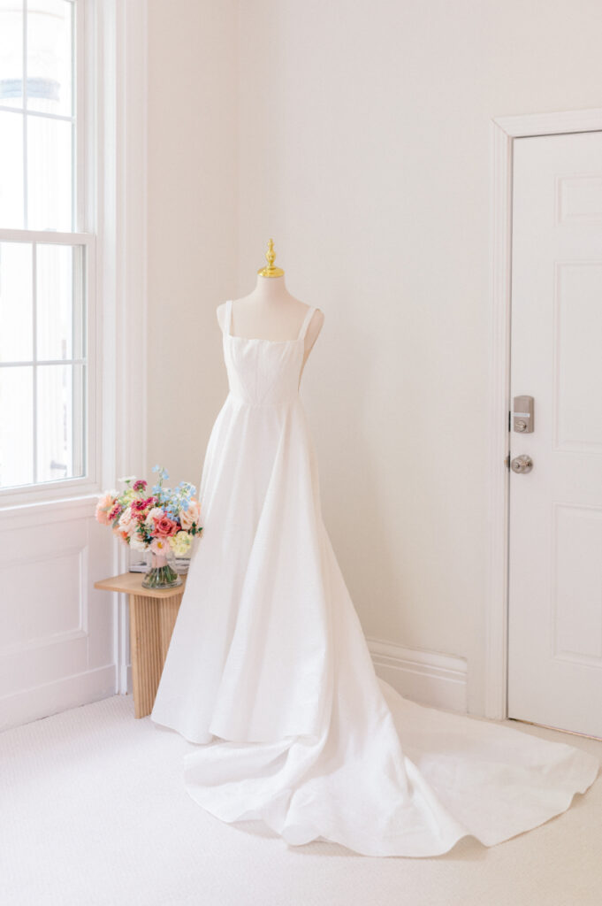 Brides stunning and classic wedding gown and warm blush tone bouquet 