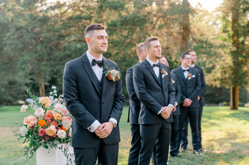 Groom watching his bride walk down the isle