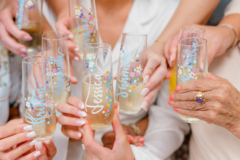 Bride and her bridesmaids sharing a toast while they are getting ready 