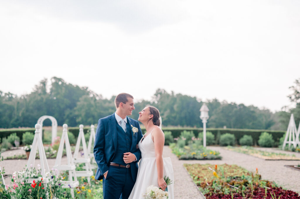 Couple stand arm in arm amidst the newly created garden at this Smith Farm Gardens Wedding