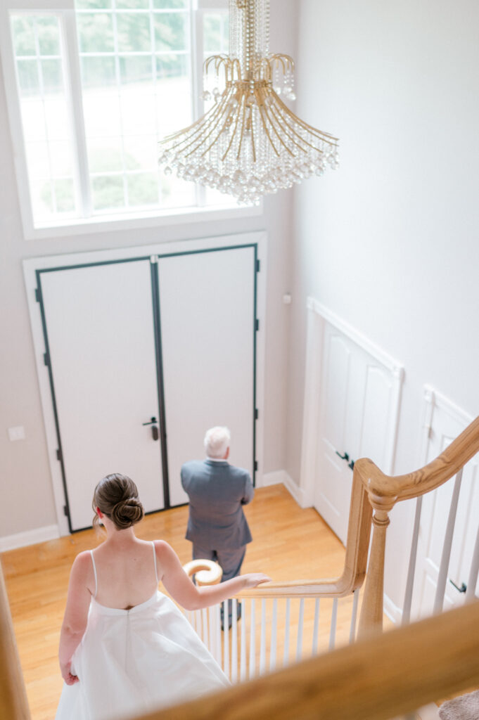 Overhead view of bride approaching father for heartfelt first look on wedding day