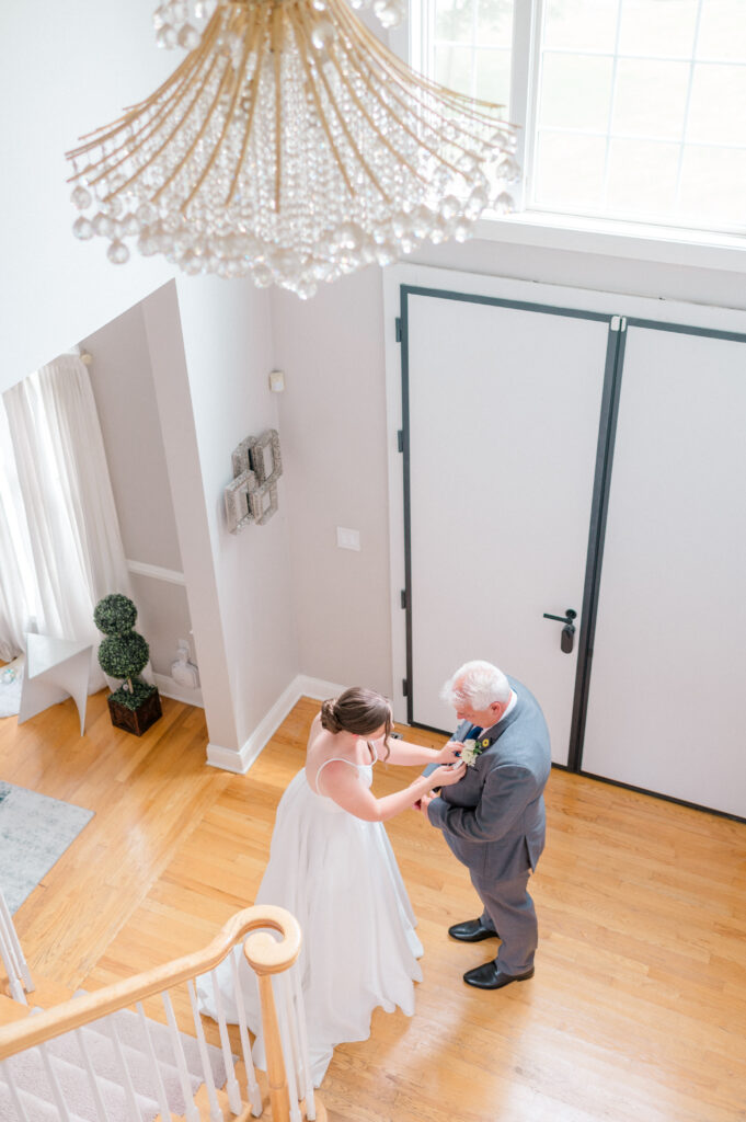 Bride helping finding custom photograph tie during special moment before Smith Farm Gardens wedding