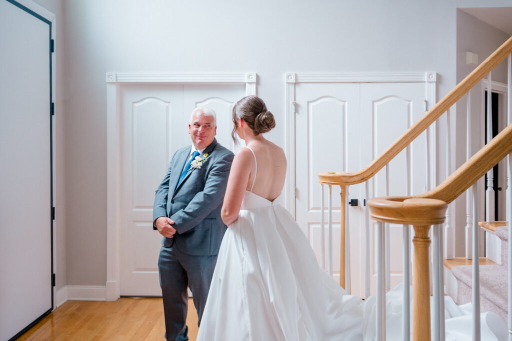 Bride’s emotional first look with her father inside family home on the morning of the wedding
