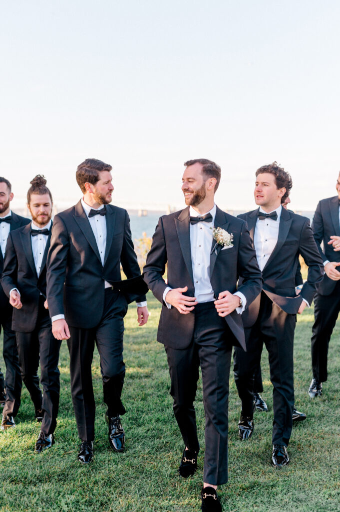 Groom surrounded by groomsmen all dressed in chic black tie.