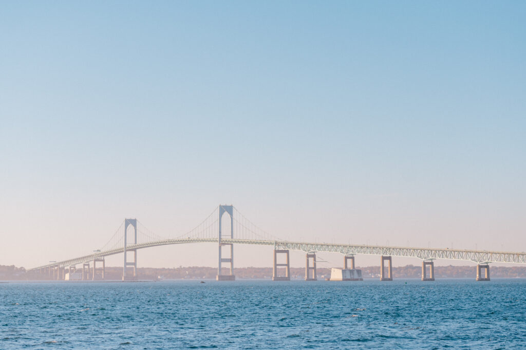 Panoramic view of the Newport Bridge stretching across the coastal waters near Newport Harbor Island Resort, captured on a clear day.