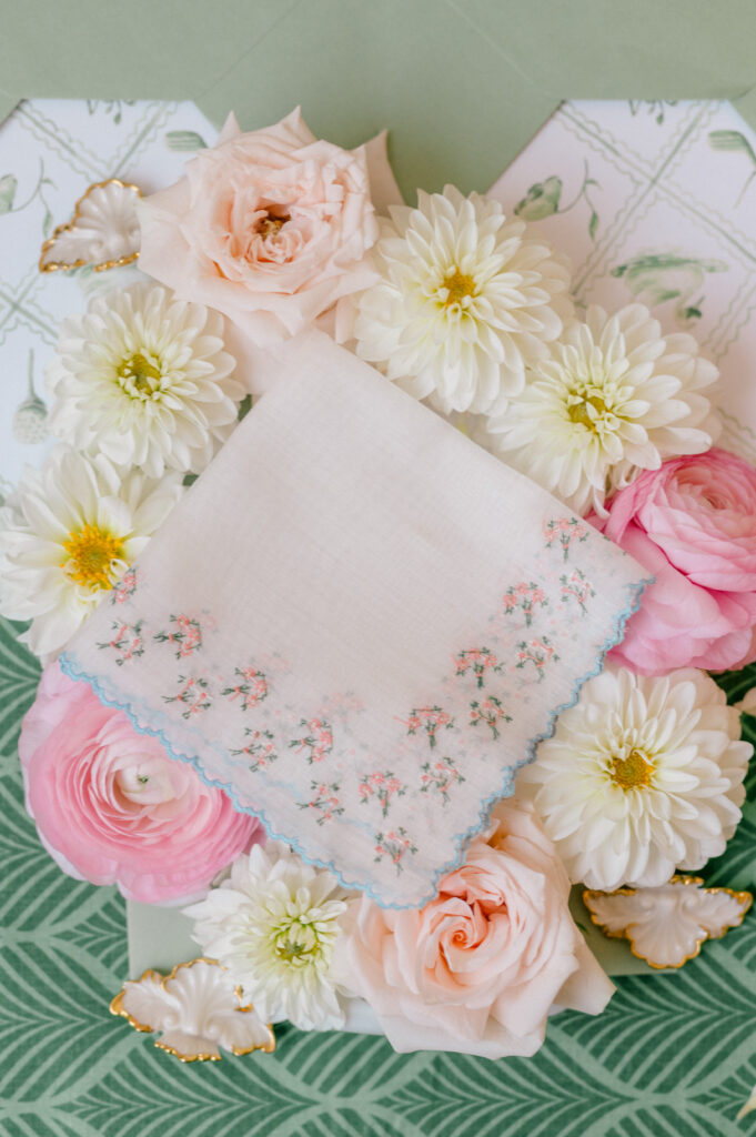 Elegant blush and ivory wedding handkerchief surrounded by garden roses and dahlias at a TPC River Highlands wedding, photographed by Jennifer Nichole & Co.