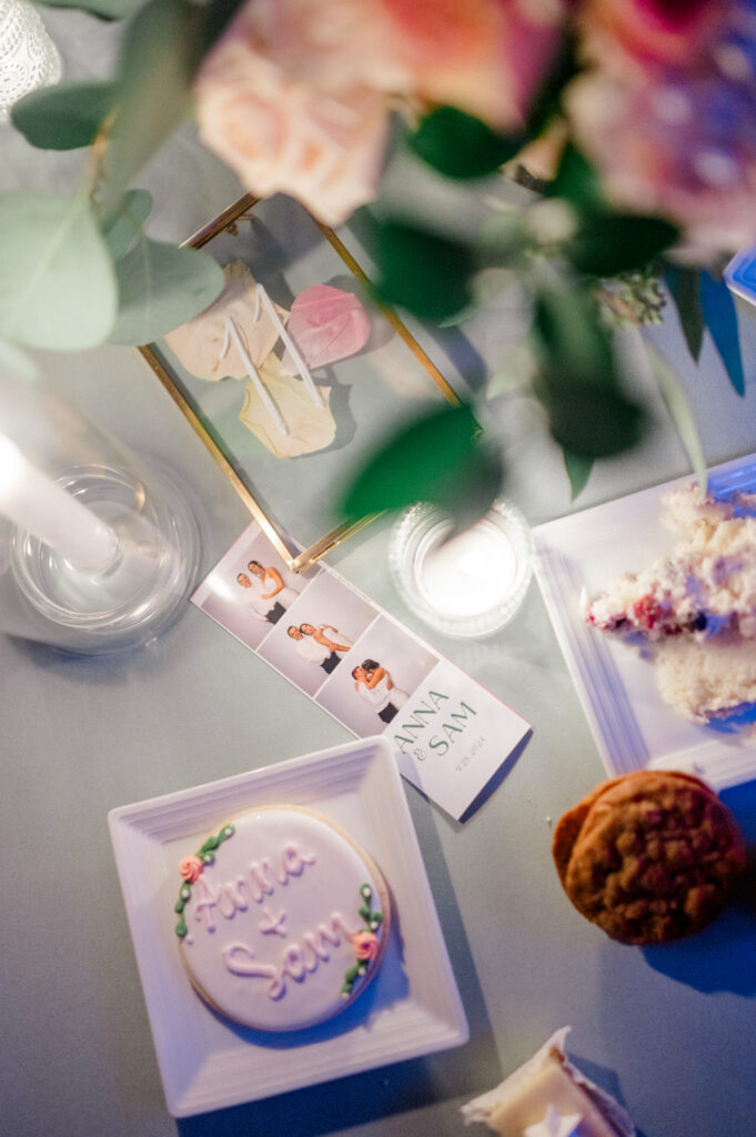Personalized wedding details including custom cookie, photo booth pictures, and desserts styled for reception decor, part of a Connecticut wedding photography timeline by Jennifer Nichole.