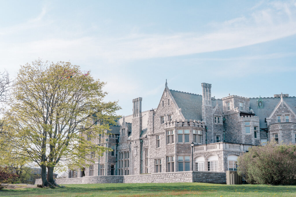 Side view of Branford House Mansion with spring greenery and blue skies, ideal for outdoor weddings in Connecticut