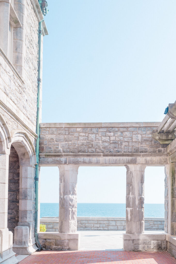 Ocean-facing stone arches and terrace at Branford House, ideal ceremony location for coastal Connecticut weddings