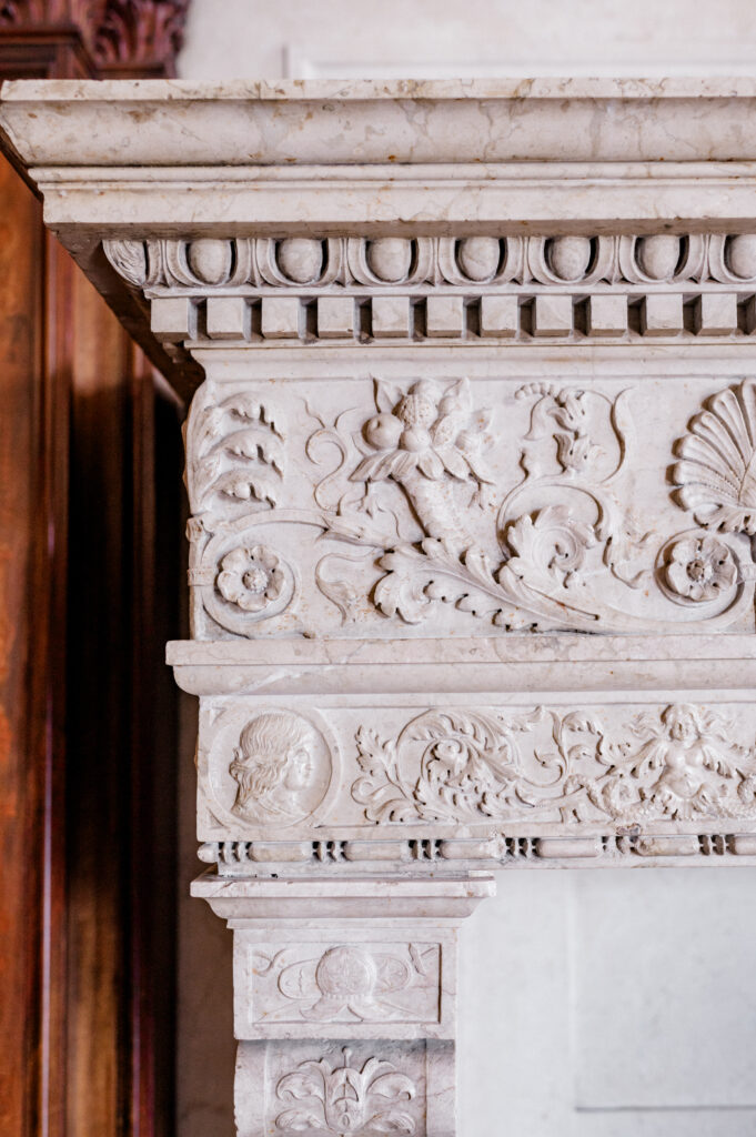 Antique marble fireplace detail at Branford House, showcasing classical artistry in this elegant wedding venue