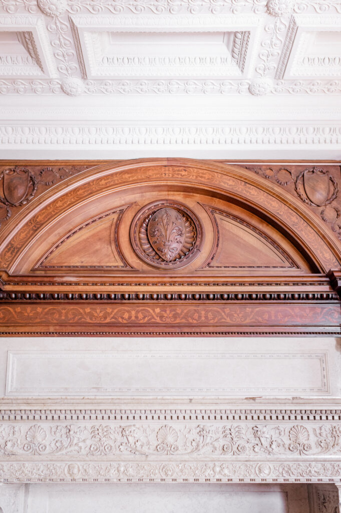 Close-up of carved wood and white ceiling detail at Branford House, showcasing elegant historic architecture