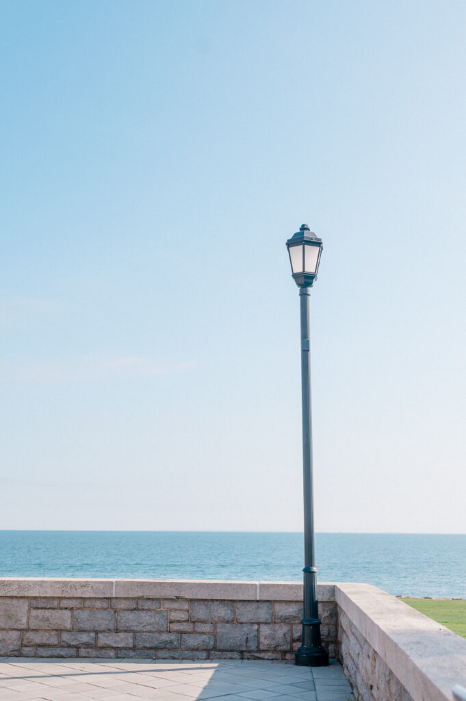 Romantic stone terrace with ocean view and vintage lamppost at Branford House in Groton, CT