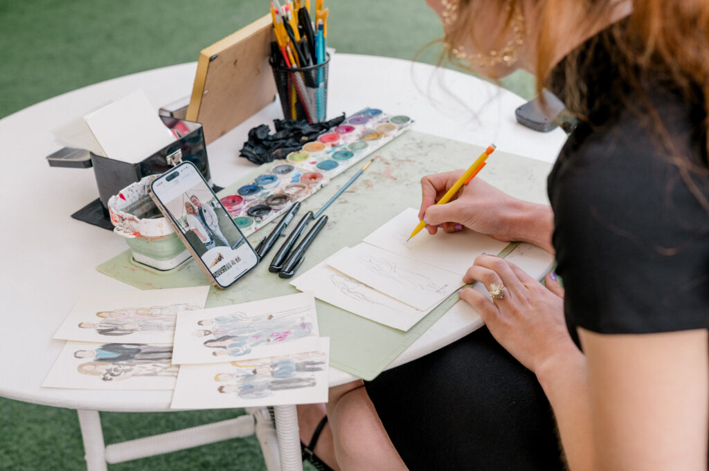 Wedding guest artist creates custom watercolor portraits during reception at Smith Farm Gardens wedding.