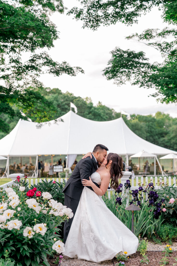 Bride and groom kissing in an open garden at Smith Farm Gardens during golden hour by Jennifer Nichole photography