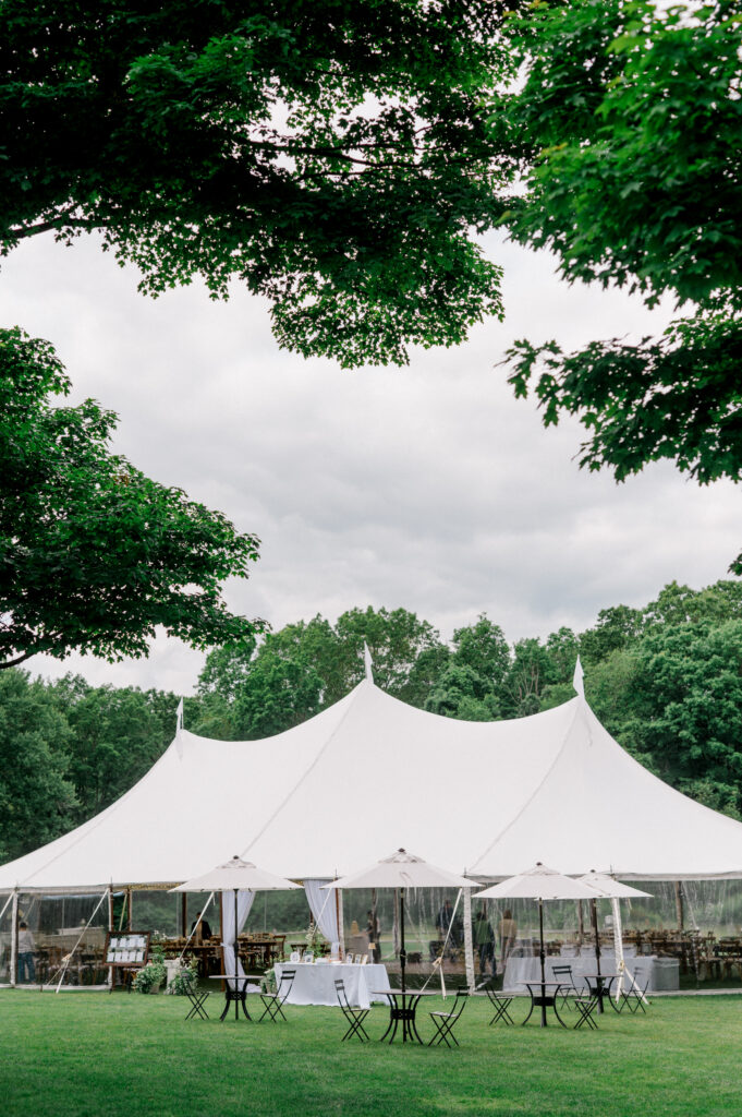 Elegant white sailcloth reception tent set up on the lawn at Smith Farm Gardens for a Connecticut wedding celebration.