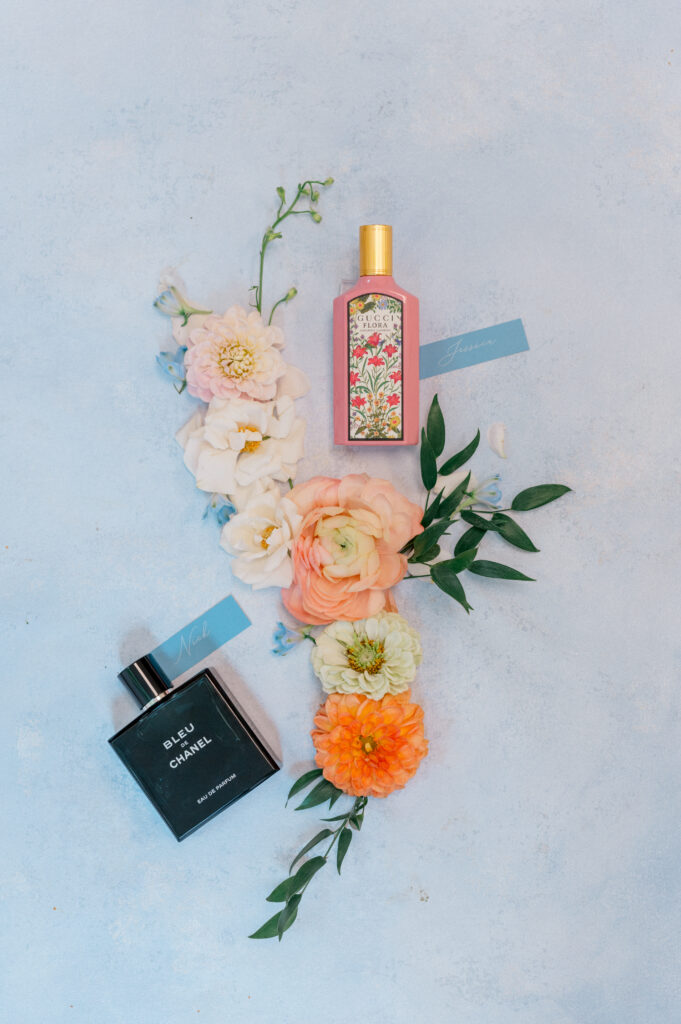 His and hers wedding perfumes styled with seasonal florals and name tags for a colorful and personal wedding morning.